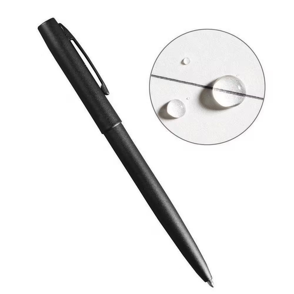 Matte black all-weather tactical pen with clip shown writing through water droplets on white paper.
