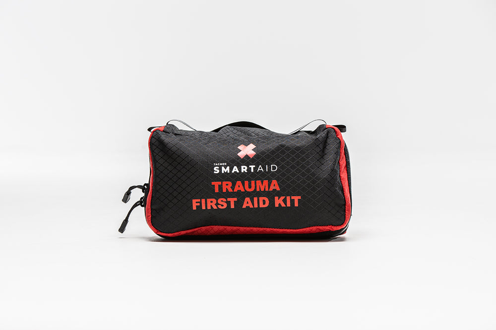 Black vehicle trauma kit with red trim and white text reading 'TRAUMA FIRST AID KIT' on the front.