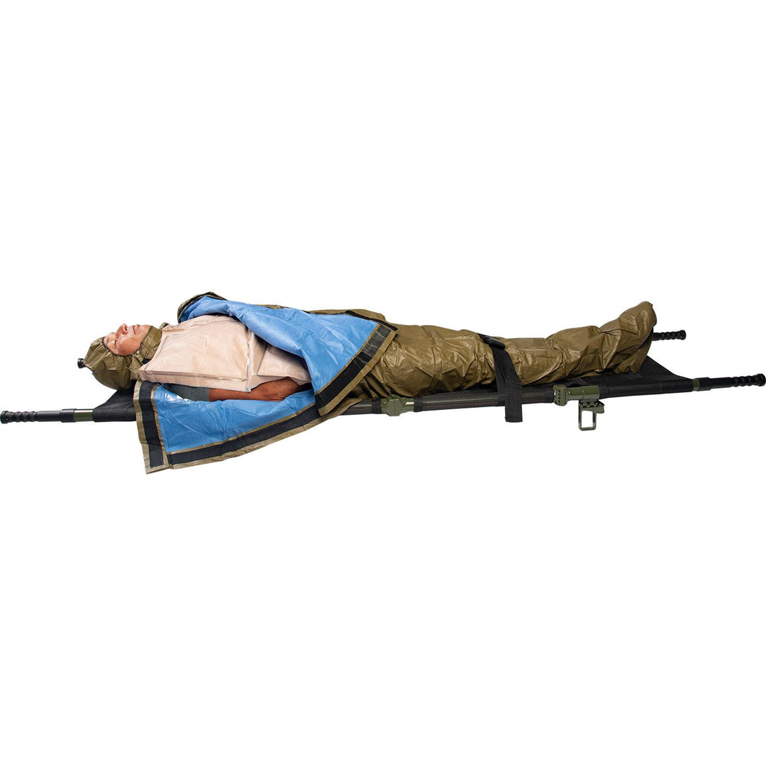 HPMK for the prevention of hypothermia during casualty care, the patented HPMK® with reinforced Heat Reflective Shell is strong, flexible, lightweight & impervious to wind & rain. Image shows a patient wrapped in the HPMK