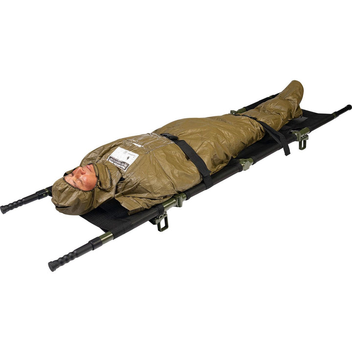HPMK for the prevention of hypothermia during casualty care, the patented HPMK® with reinforced Heat Reflective Shell is strong, flexible, lightweight & impervious to wind & rain. Image shows a patient wrapped in the HPMK