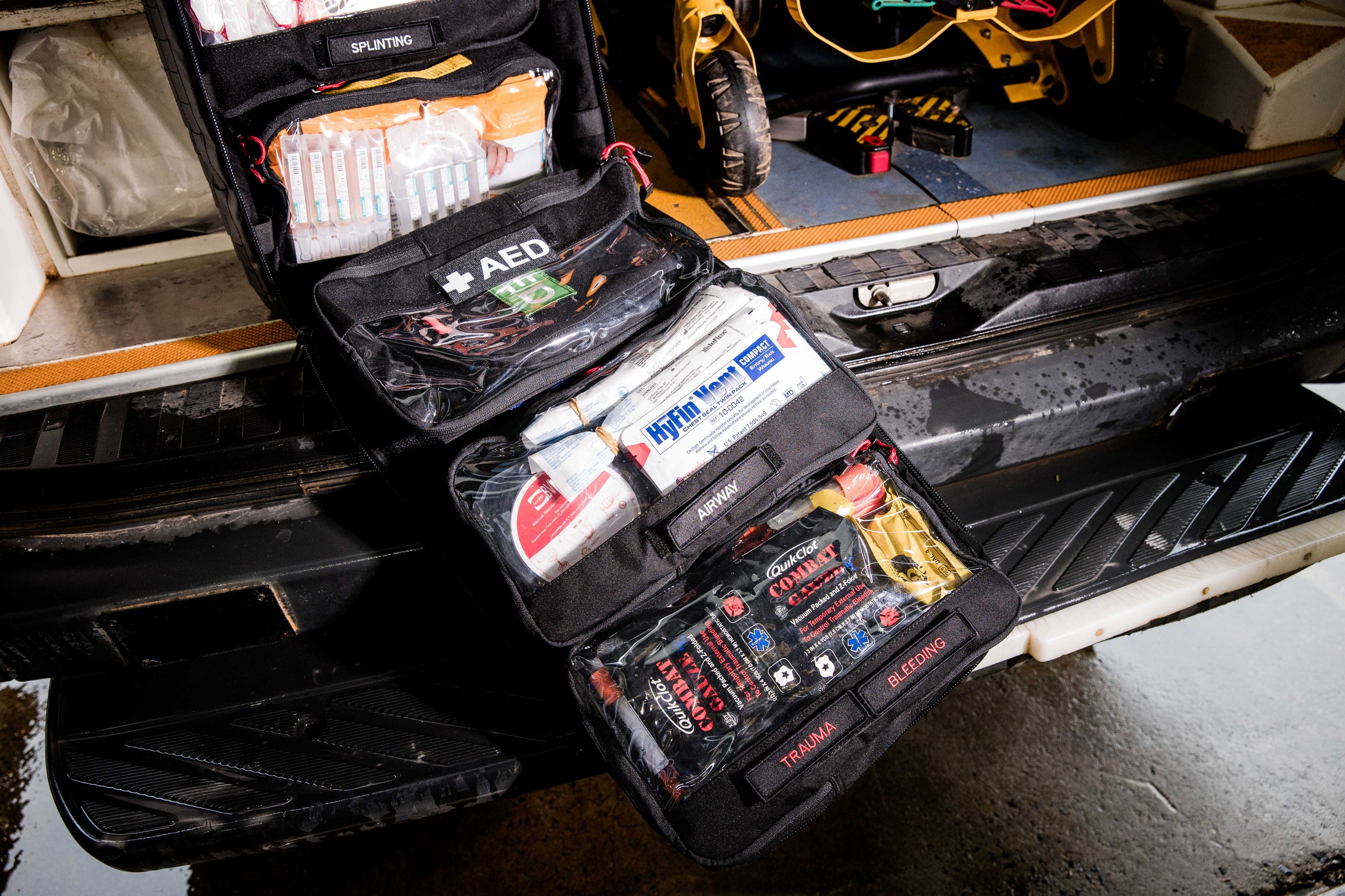 Custom medical response kit with labeled compartments for AED, airway, and bleeding control, opened in vehicle boot. Designed for high-risk worksites and remote teams. TacMed Australia – experts in custom first aid kits for industry.