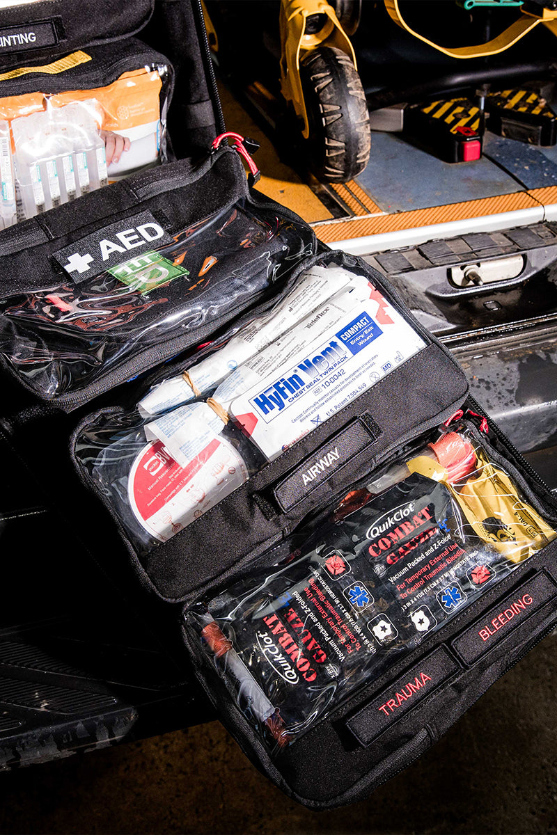 Custom medical response kit with labeled compartments for AED, airway, and bleeding control, opened in vehicle boot. Designed for high-risk worksites and remote teams. TacMed Australia – experts in custom first aid kits for industry.