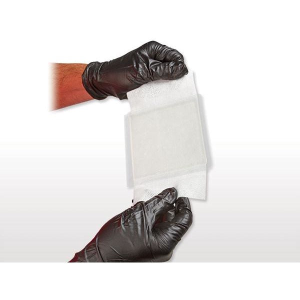 Gloved hand holding semi-transparent BurnTec dressing. Ready for application to burns, scalds, or abrasions. TacMed Australia – professional-grade hydrogel treatment.