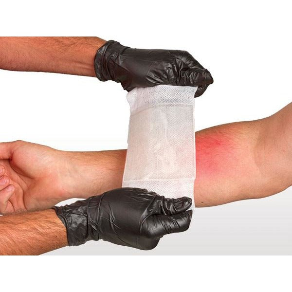 BurnTec dressing being applied to forearm by gloved hands. Provides immediate cooling and pain relief. TacMed Australia – essential for first aid and field burn management.