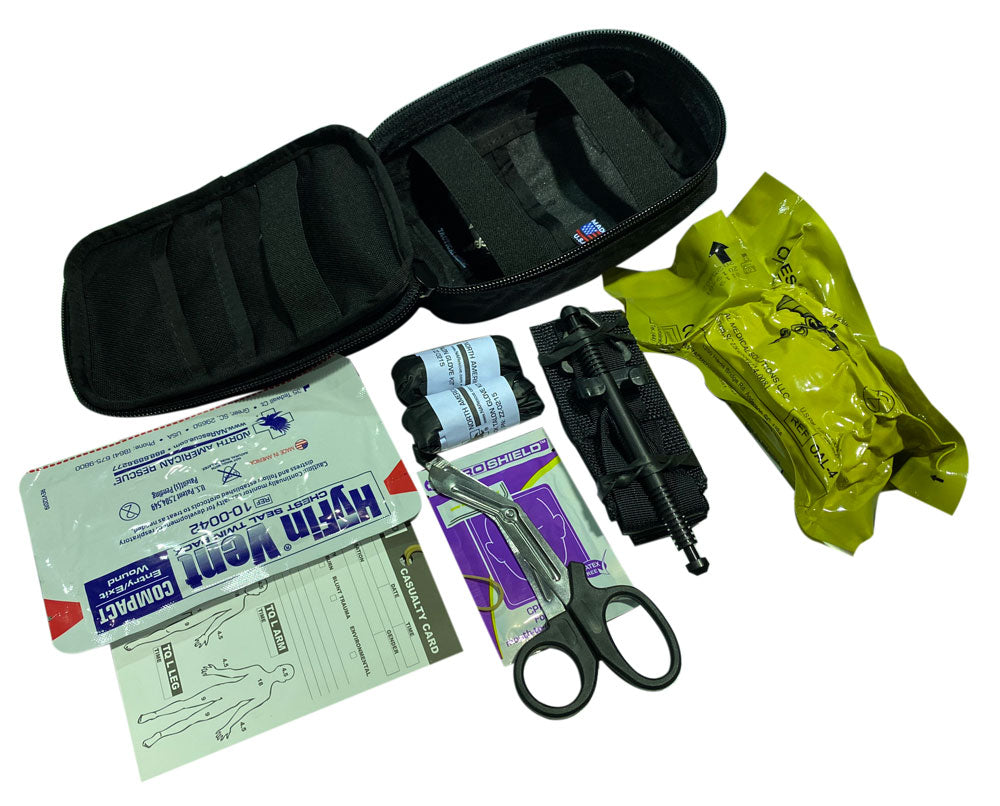 Operator IFAK Kit contents including tourniquet, trauma shears, HyFin Vent, gloves, and compressed gauze beside MOLLE pouch. Designed for individual trauma response in high-threat environments. TacMed Australia – comprehensive IFAK for tactical medics.