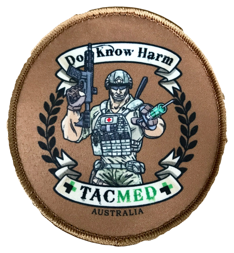Round tan patch featuring an armed tactical medic in uniform with the text 'Do Know Harm' above and 'TACMED AUSTRALIA' below, surrounded by black laurel graphics.