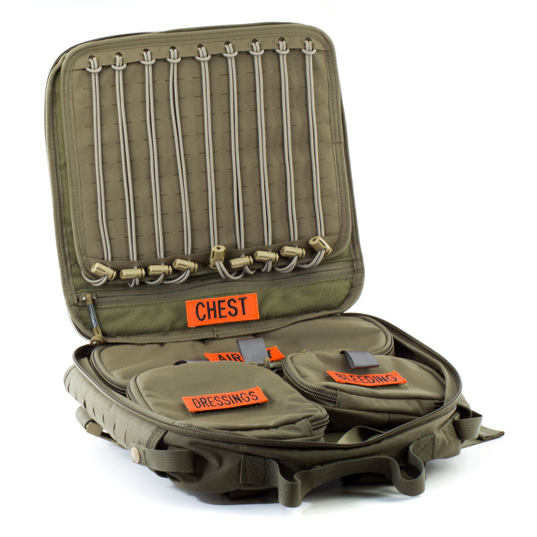 Open aid bag showing internal elastic retention and labeled pouches for CHST, ABDMN, and other modules.