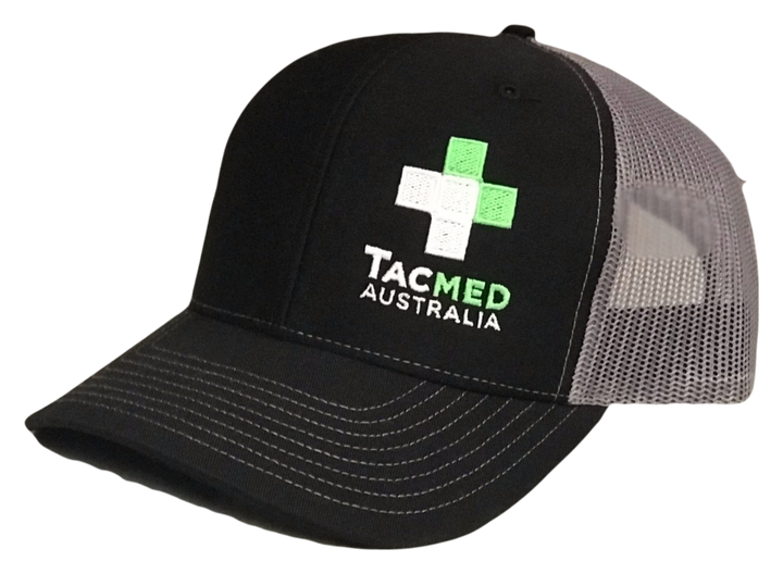 Black and grey TacMed Australia trucker cap with embroidered green and white cross logo on the front.