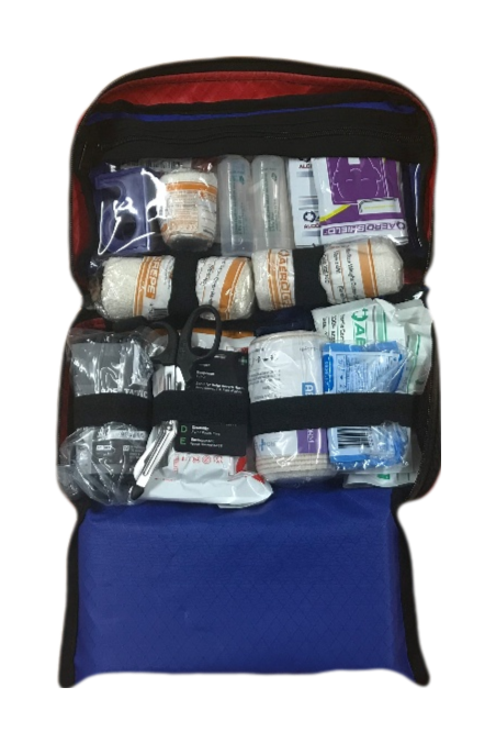 Open blue trauma kit displaying organised medical supplies including bandages, gauze, shears, and dressings in clear compartments.
