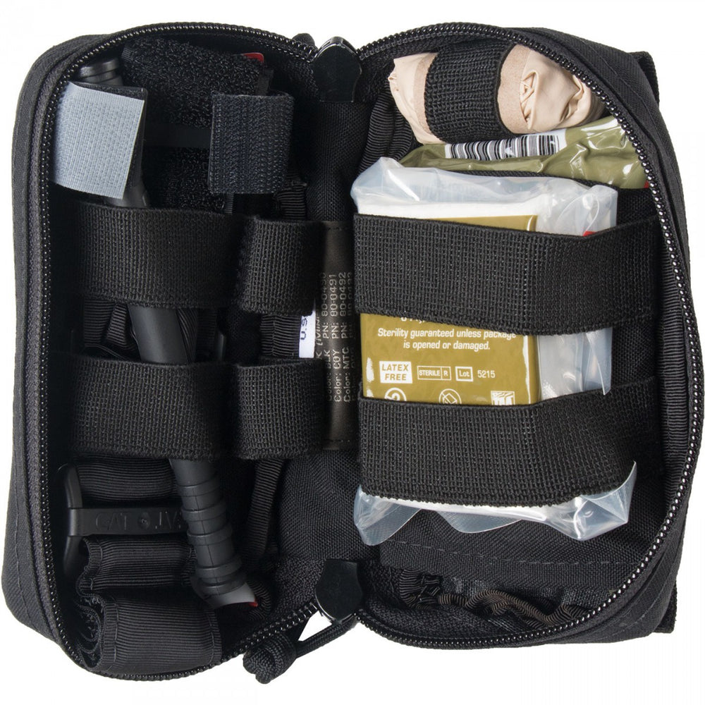 Interior view of M-FAK showing packed trauma supplies including bandages and medical tools secured with elastic straps.