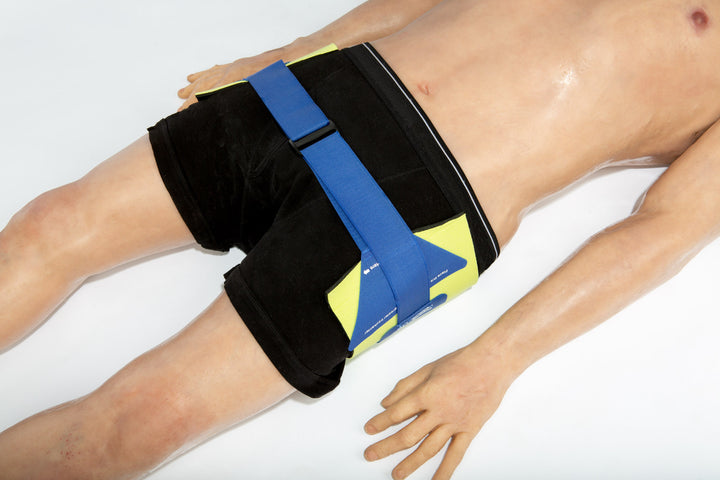 Prometheus Pelvic Splint secured around a patient's pelvis, demonstrating correct application on a casualty.