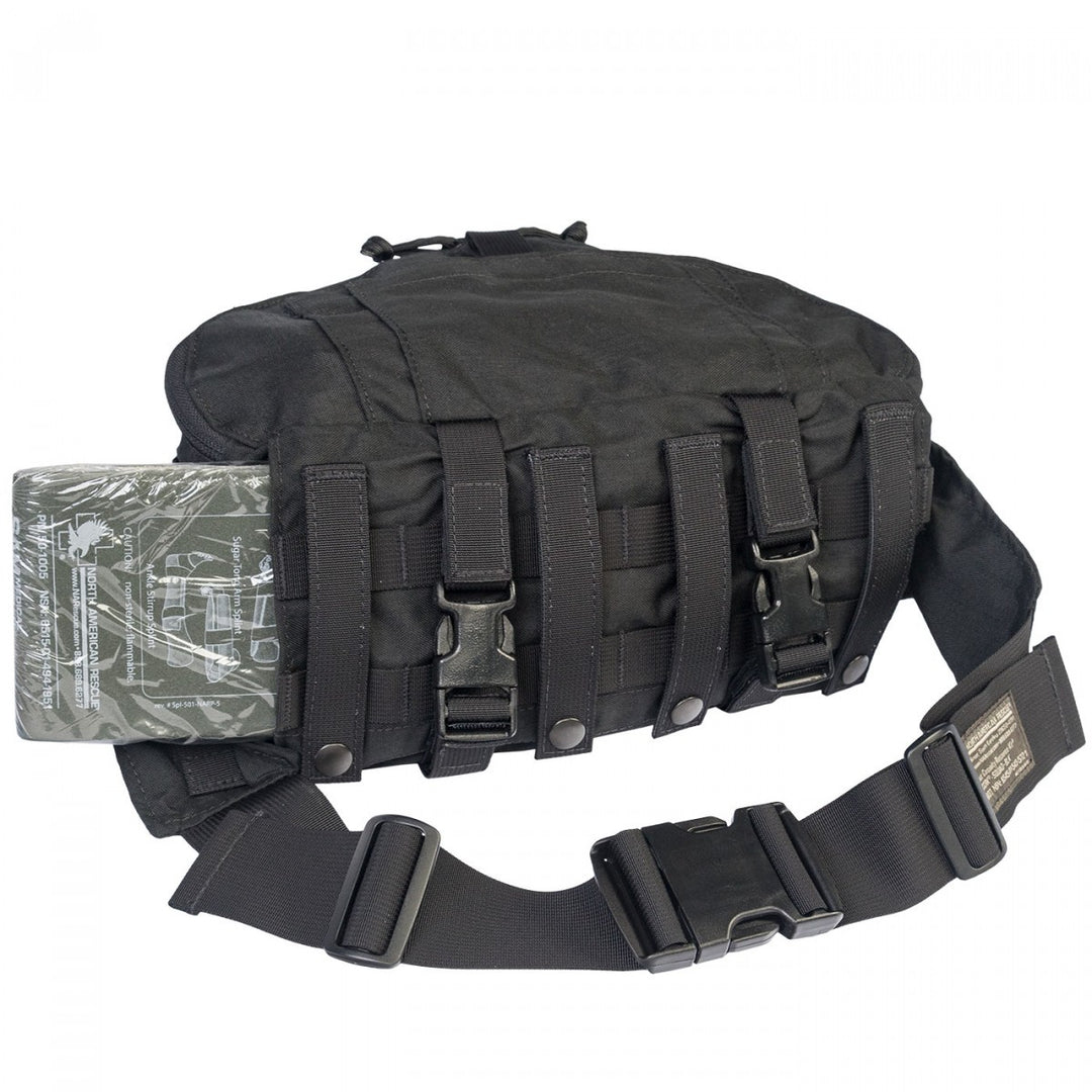 TacMed trauma kit attached to a belt system with MOLLE webbing, hydration pouch, and additional gear.