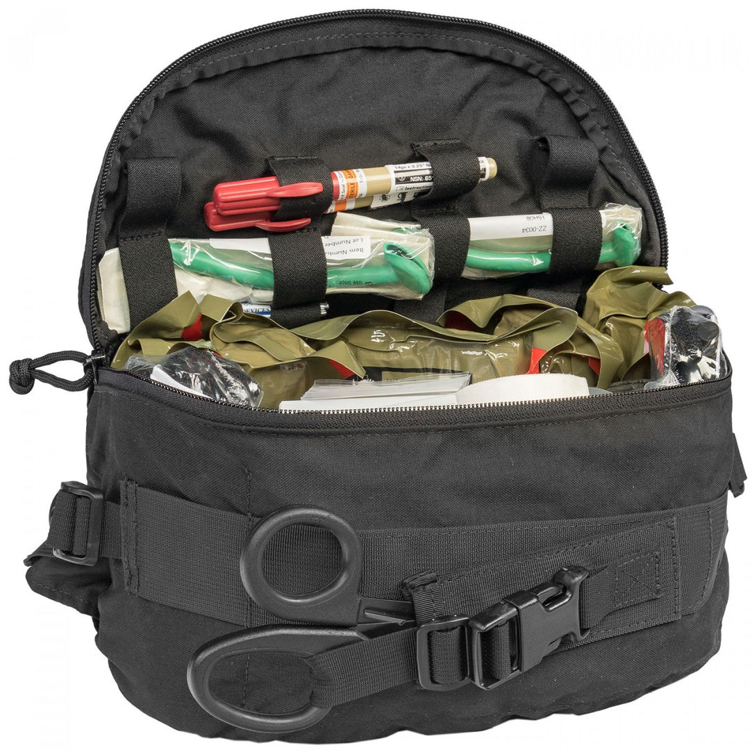 TacMed Range Safety Trauma Kit fully opened, displaying neatly packed medical contents including bandages, shears, and a tourniquet.