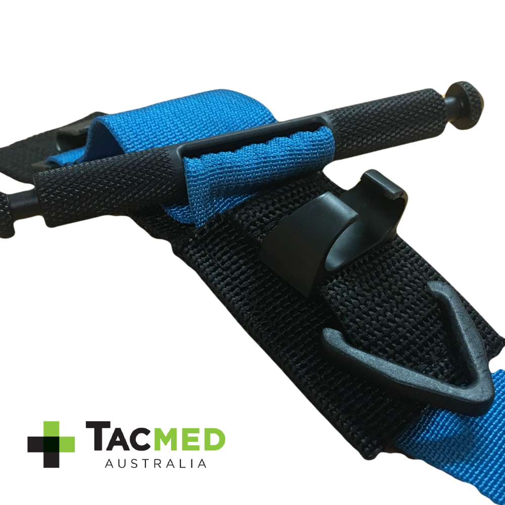 Close-up of a blue SOF-T tourniquet secured with a black retention assistance clip, featuring the TacMed Australia logo.