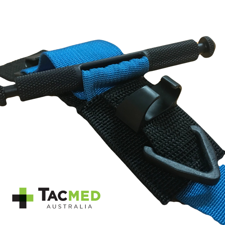 Close-up of a blue SOF-T tourniquet secured with a black retention assistance clip, featuring the TacMed Australia logo.