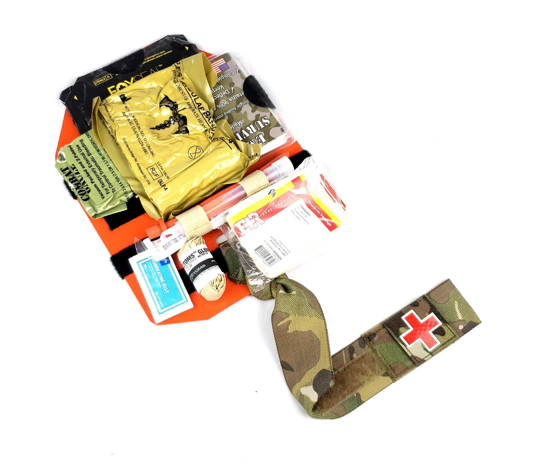 Assembled Med Plate with medical supplies secured to the orange base and black lanyard extended.