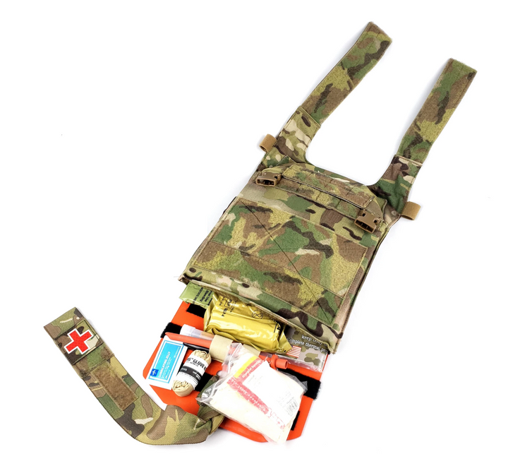Complete Med Plate system packed into camouflage carrier pouch with orange baseplate partially visible.