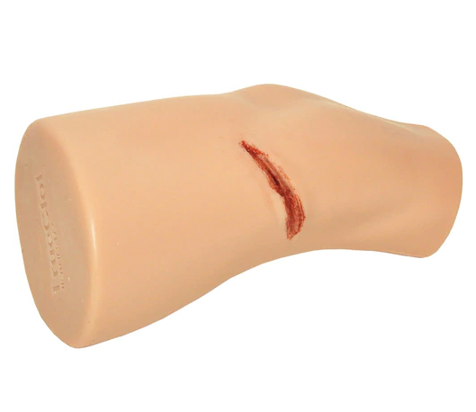 Close-up of simulated arm with open deep laceration for wound packing practice.