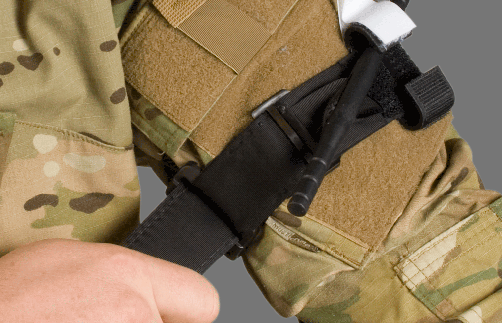 CAT Tourniquet in black applied to arm over tactical uniform in a field scenario. Built for use in military trauma care and self-application under pressure. TacMed Australia – reliable tourniquets for operational responders.