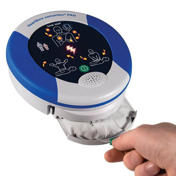 User pulling out the integrated electrode pad cartridge from the device.