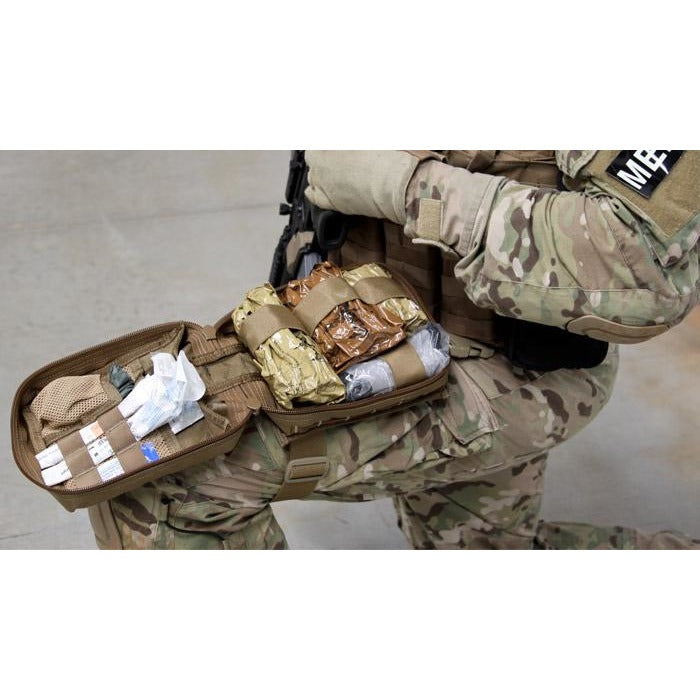 Drop leg pouch unfolded on operator’s leg, revealing organised internal compartments.