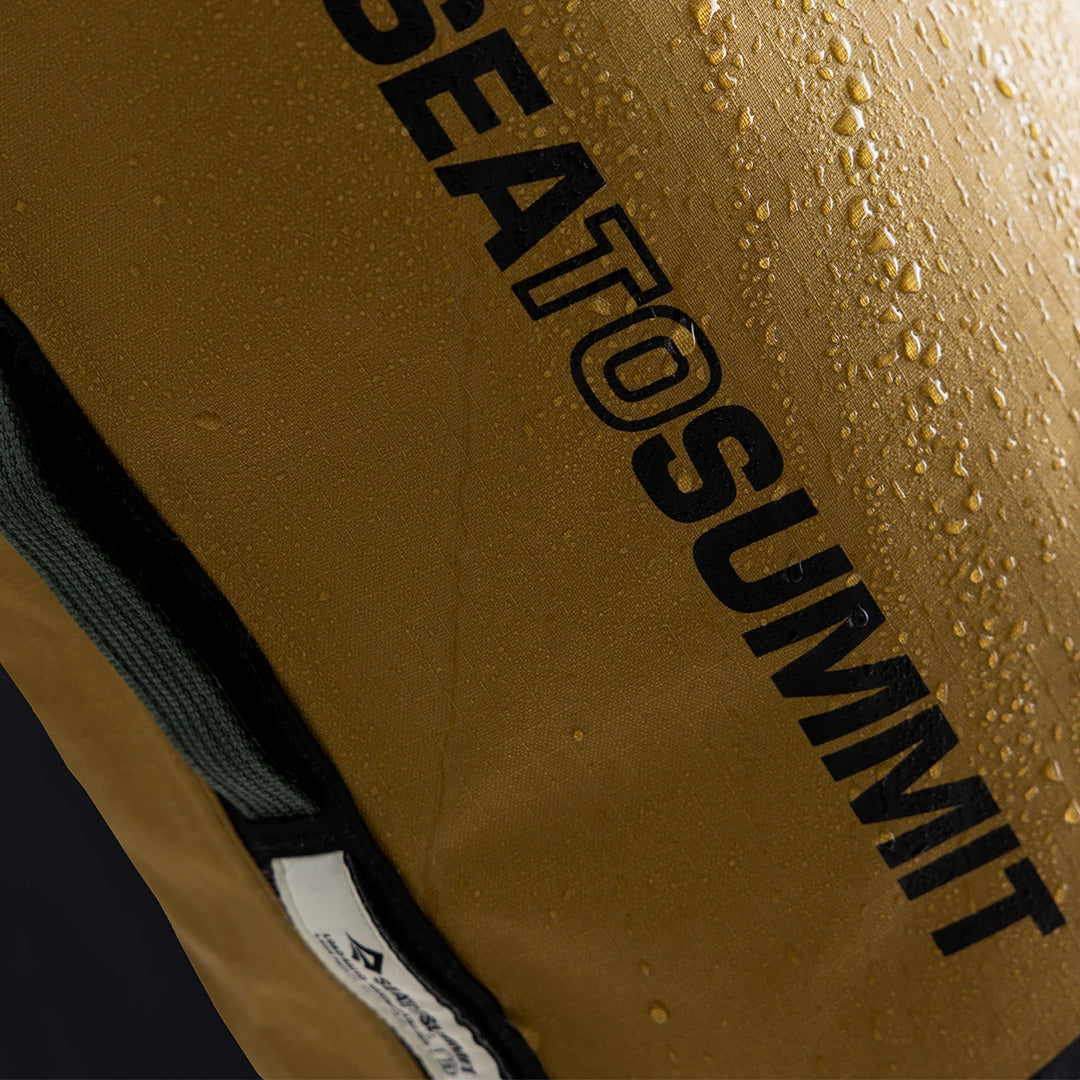 Embossed Sea to Summit branding on yellow nylon fabric

