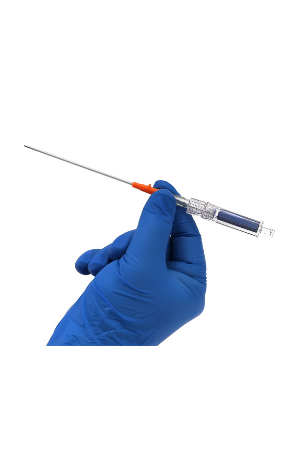 The image shows a gloved hand holding a medical device, specifically a needle or syringe with a long, thin needle attached. The hand is wearing a blue nitrile glove, and the syringe has a transparent body with a blue plunger and an orange needle cap. The background is plain white, emphasizing the medical tool.