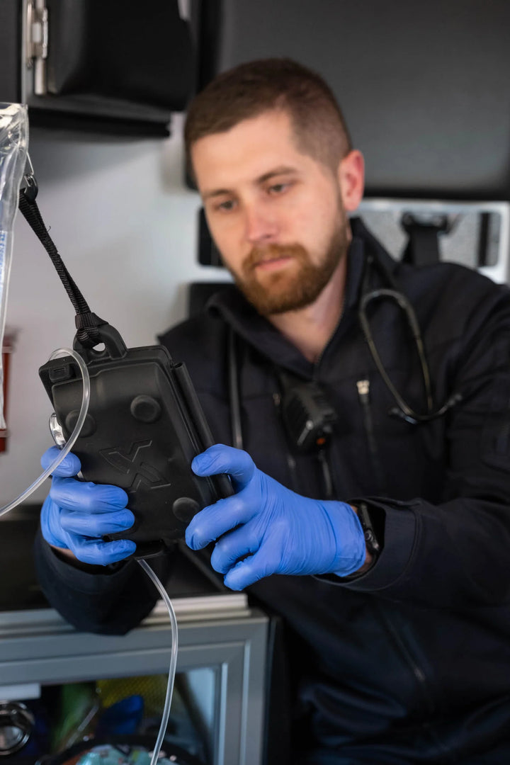 Paramedic using Sapphire™ IV Pump with protective XShear cover

