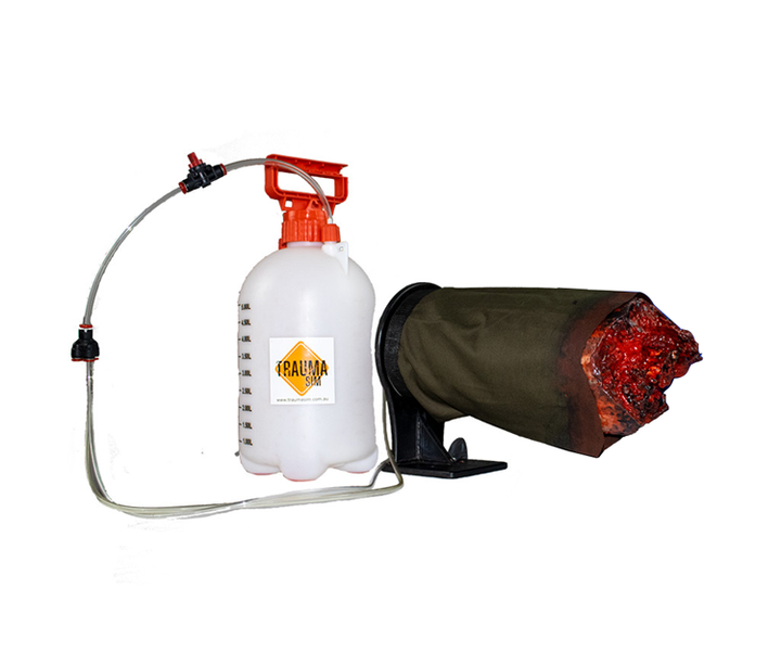 Camouflaged leg wound trainer set up with bleeding system for field simulations.