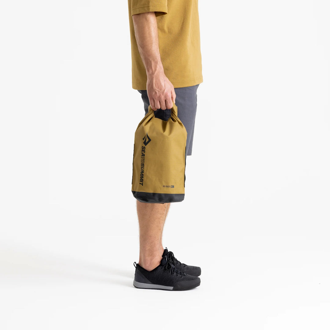 Bag held at side for size reference against leg

