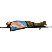 Tactical medics in white gear using the HPMK-I™ (Insulated) on a casualty in a snowy environment. The tan and blue insulated blanket is secured on a stretcher, with medical supplies visible, highlighting its field readiness.