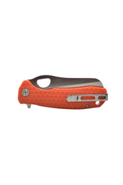 Orange Honey Badger rescue knife in closed position showing pocket clip side and satin finish blade edge