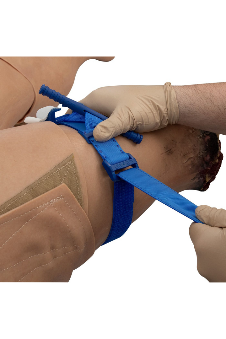 TOMManikin Blast close up image of a first responder applying a blue C-A-T tourniquet to the amputated leg
