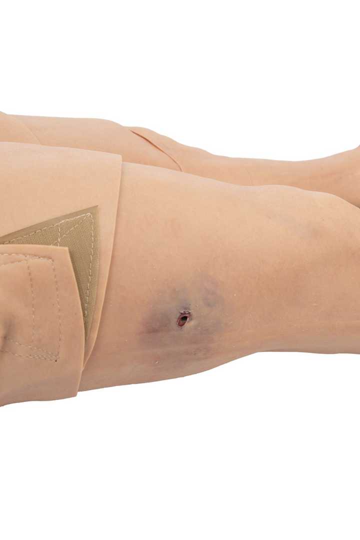 TOMManikin - GSW close up of small gun shot wound with surrounding bruising on his leg.