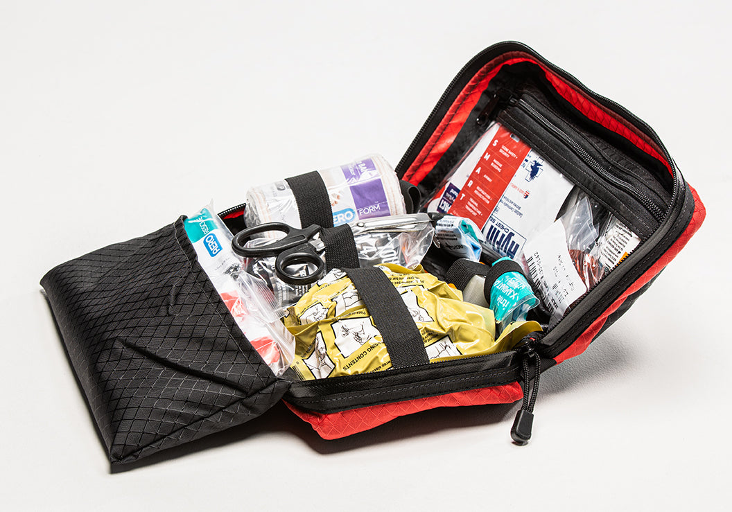 TacMed SmartAid trauma kit opened to show neatly organized internal compartments with medical supplies.