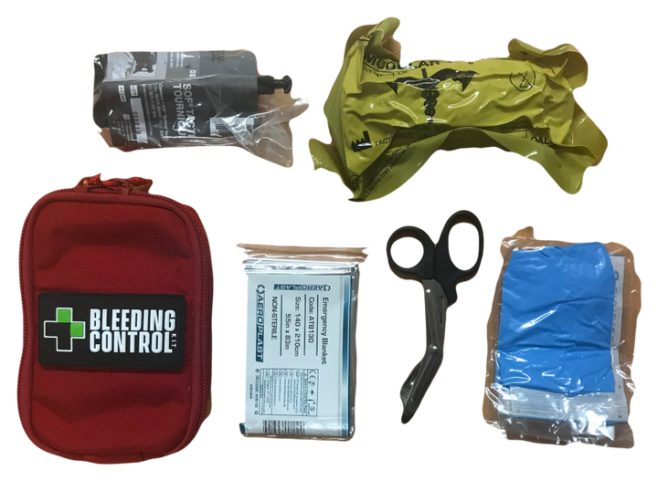 Kit components laid out: red pouch, tourniquet, emergency bandage, gloves, trauma shears, and chest seal.