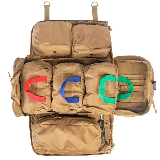 NAR Multi Mission Trauma Pack in tan, a rugged backpack with 3200 cubic inch capacity for tactical medics. Features six detachable compartments, internal MOLLE with hook-and-loop, a multi-mission belt, and rappelling loops. Converts into a trauma sheet for vehicle or aircraft use. Includes North American Rescue branding. Bag only, gear sold separately