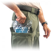 Packaged NAR QuikLitter Lite Multi-Use Disposable Litter in black with blue label  shown being placed into a mans pants pocket. Used for remote emergency scenarios where a compact extrication device is required.