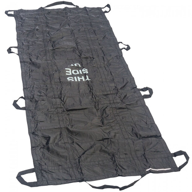 Black North American Rescue QuikLitter Lite out of packing and shown laying flat on a white background with THIS SIDE UP displayed. Used for remote emergency scenarios where a compact extrication device is required.