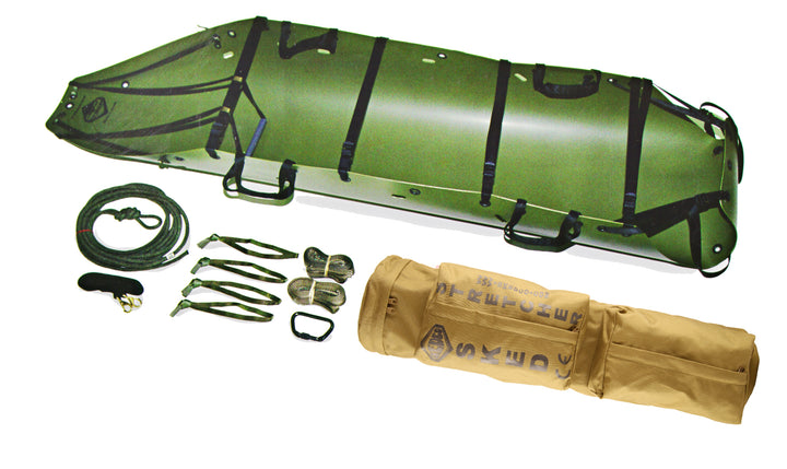 Green Sked rescue stretcher with accessories including carabiners, rope, and rolled carry bag.
