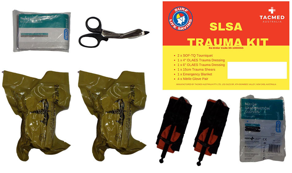 Contents of the SLSA Trauma Kit laid out, including trauma shears, emergency bandages, twin tourniquets, hemostatic gauze, and a red-and-yellow SLSA branded instruction card.