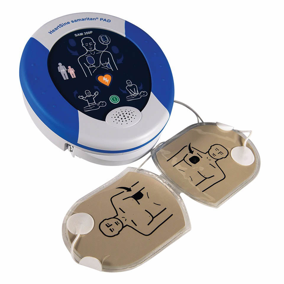 HeartSine defibrillator shown with electrode pads detached and ready for application.