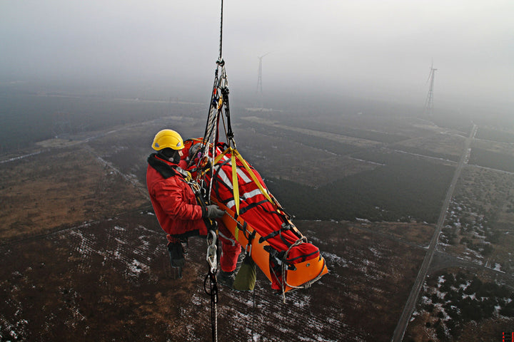 High-angle aerial rescue scenario using the Sked stretcher to hoist a patient with a rescuer during extraction.