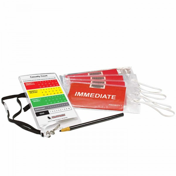 T2 Tactical Triage Kit contents laid out, including triage tags marked 'IMMEDIATE,' a casualty count card with lanyard, and a pencil